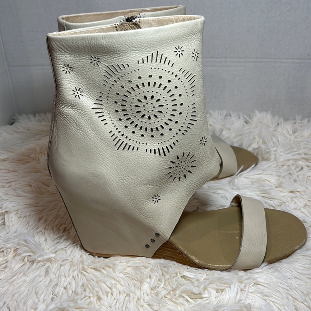 Koolaburra Perone laser detail open toe leather wedge heels.